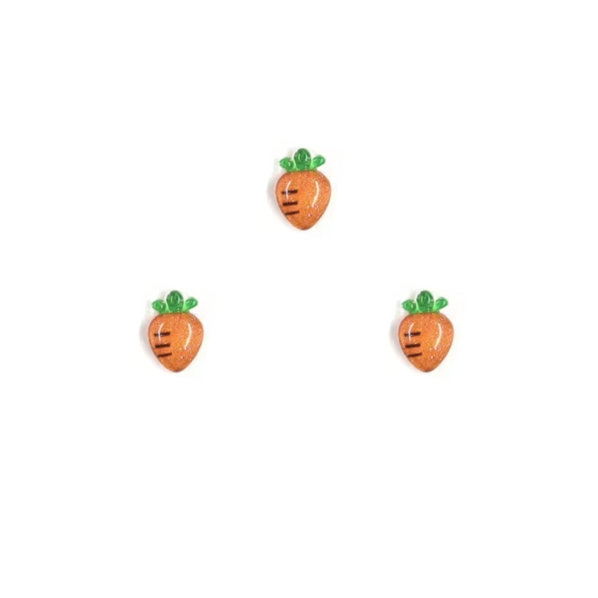 Three carrot-shaped nail charms on a white background