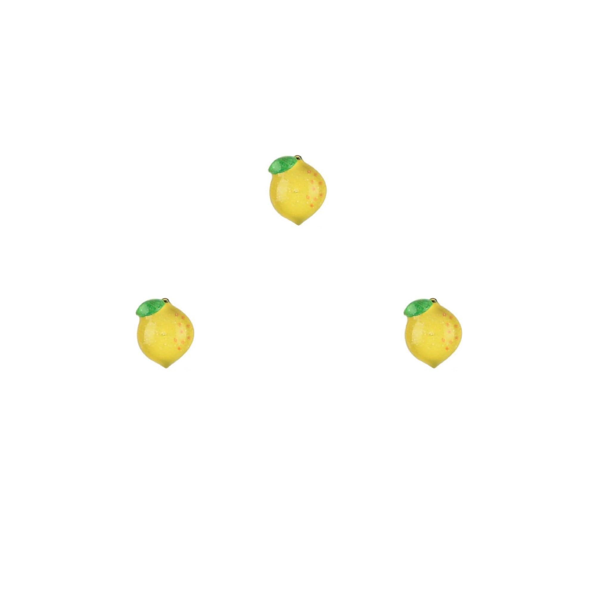 Three lemon-shaped nail charms on a white background